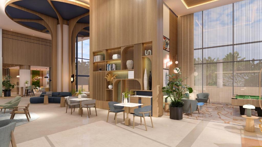 a rendering of a lobby with tables and chairs at Hampton By Hilton Jeddah Souq7 in Jeddah