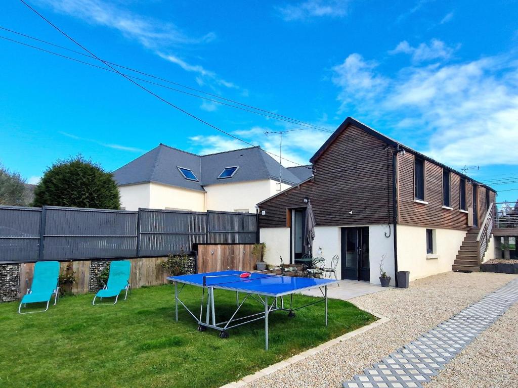 a ping pong table in the yard of a house at Holiday Home near Val-André Beach & Golf in Saint-Alban