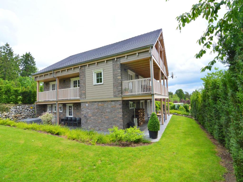 a large house with a large yard at Luxury Ardennes chalet spa in Septon