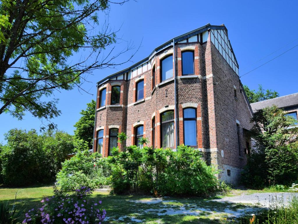 an old brick building with windows at Cozy Cottage in Durbuy with Garden in Barvaux