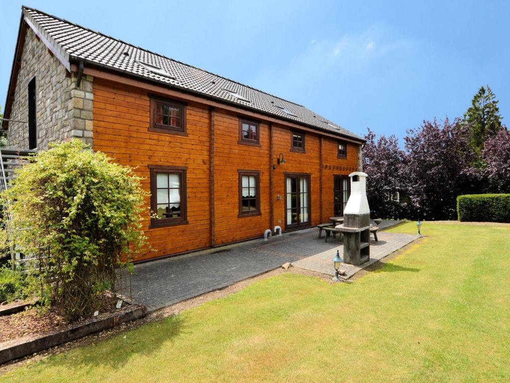 a brick house with a bench in front of it at Elegant Villa with Sauna in Durbuy