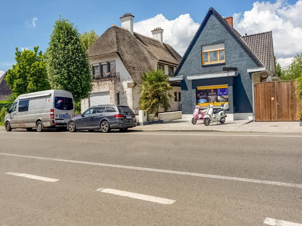 a van and cars parked in front of a house at Peaceful Getaway with Spa in Avelgem
