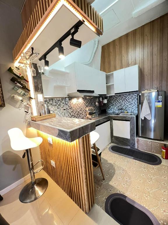 a kitchen with white cabinets and a counter top at Miestee's Happy Homes in Lapu Lapu City