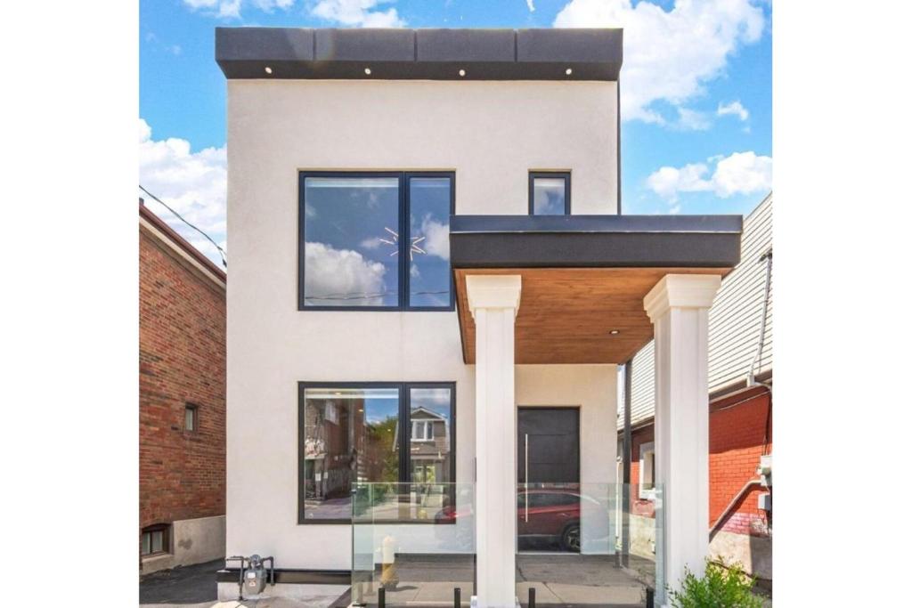 a white house with a black roof at Toronto Midtown Luxury Living in Toronto