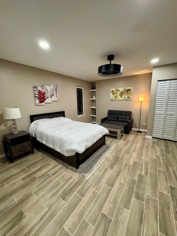 a large bedroom with a bed and a couch at VillaLuna Studio in Wellington