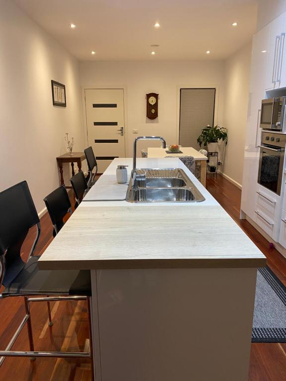 a kitchen with a sink and a counter top at Eastern Suburbs Gem in Forest Hill