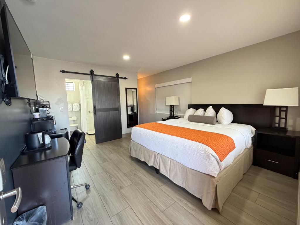 a hotel room with a large bed and a camera at The Overland Hotel Downtown Flagstaff NAU Conference Center in Flagstaff