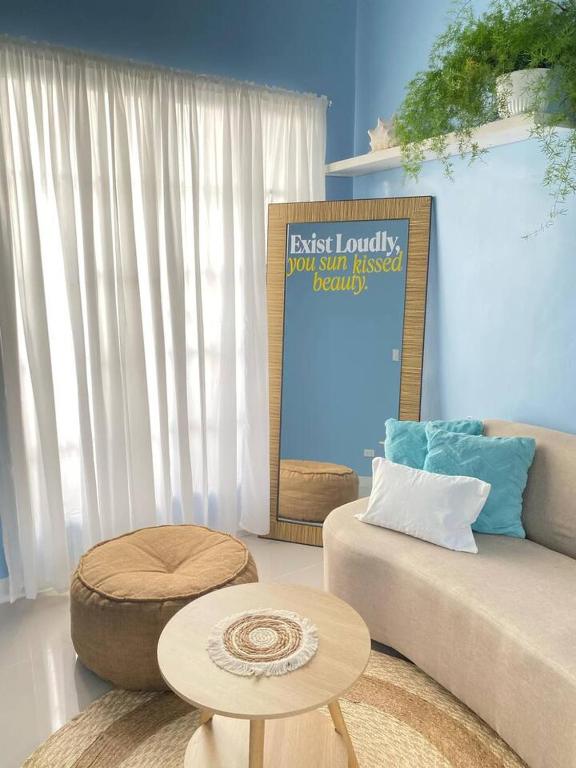 a living room with a couch and a table at 2BR w/mini dipping tub + 2 mins to beach in Mati