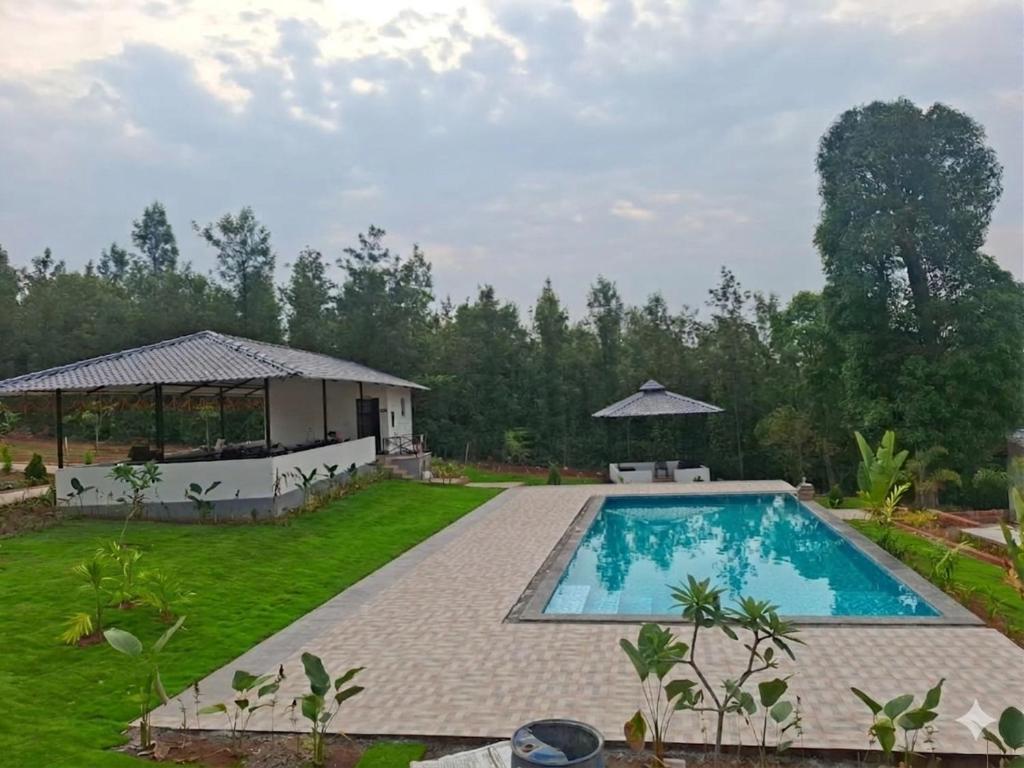 a pool in the backyard of a villa at Himabindu Stays in Sakleshpur