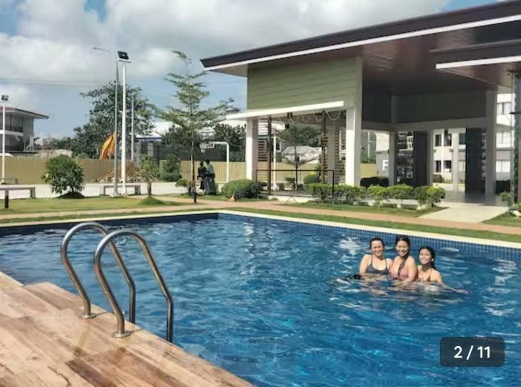 three women in a swimming pool in a building at Plumera Mactan Condo unit in Bankal