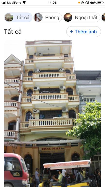 a picture of a large building with cars and people at Ks DŨNG HOA MAI in Sầm Sơn