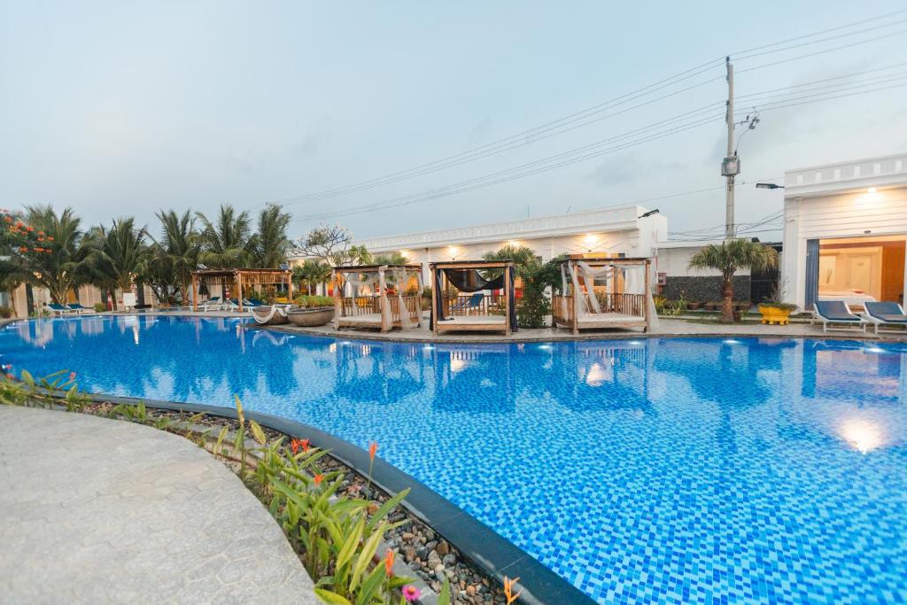 a large swimming pool with blue water at Fairy Hills Hotel in Mui Ne