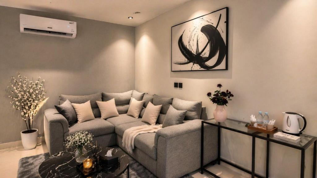 a living room with a couch and a table at Happy Villa هابي فيلا in Al Khobar