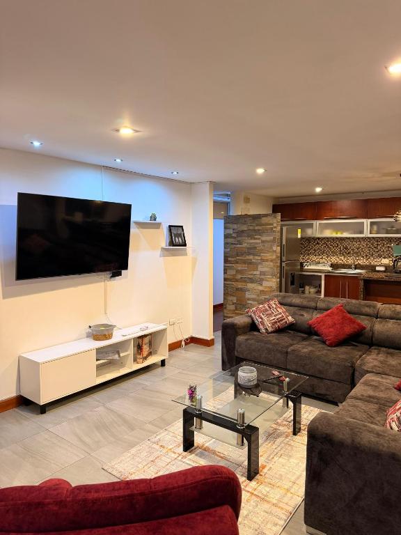 a living room with two couches and a flat screen tv at Apartamento T Premium in Ipiales