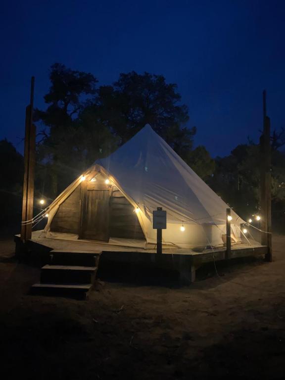 a large tent with lights in a field at night at Issachar Tent in Duchesne