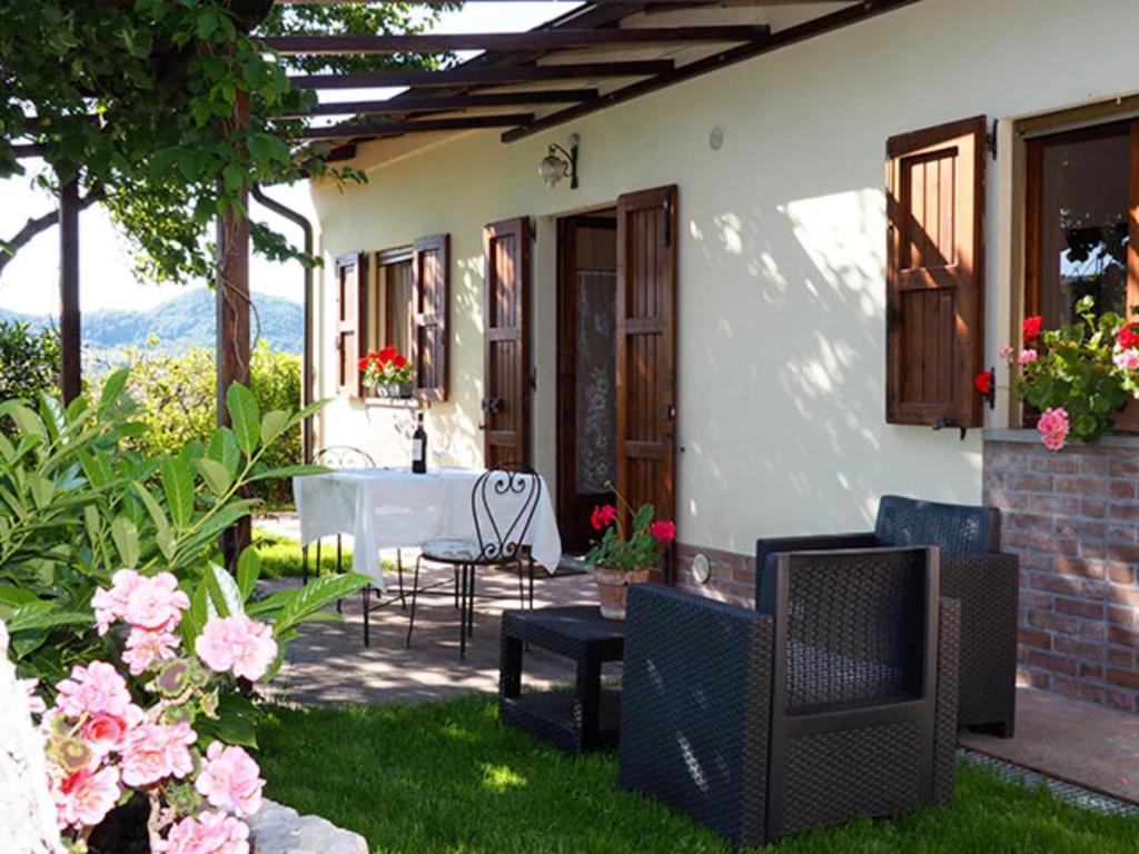 a patio of a house with a table and chairs at Farmhouse in Monte Santa Maria Tiberina with garden in Monte Santa Maria Tiberina