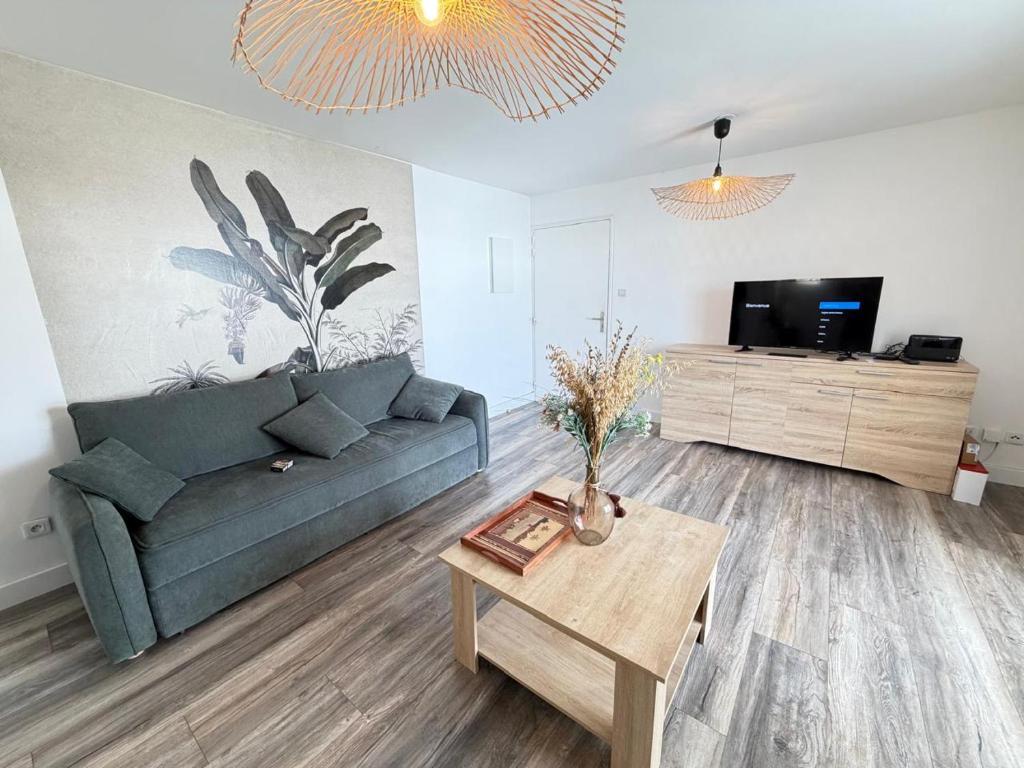 a living room with a couch and a coffee table at Le Papangue in Saint-Paul