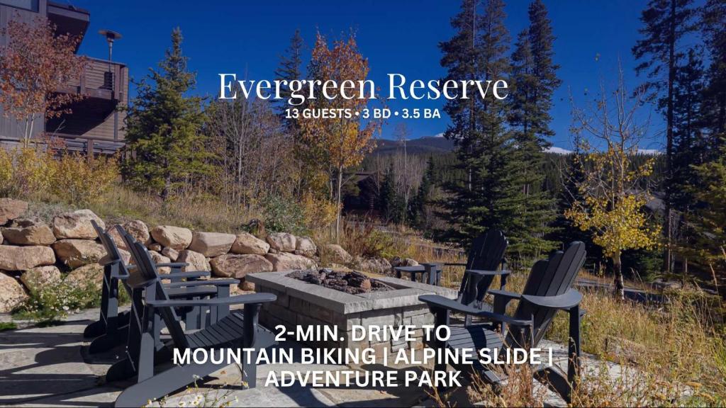 a patio with chairs and a fire pit with the event banner for evergreen reserve at Evergreen Reserve in Winter Park