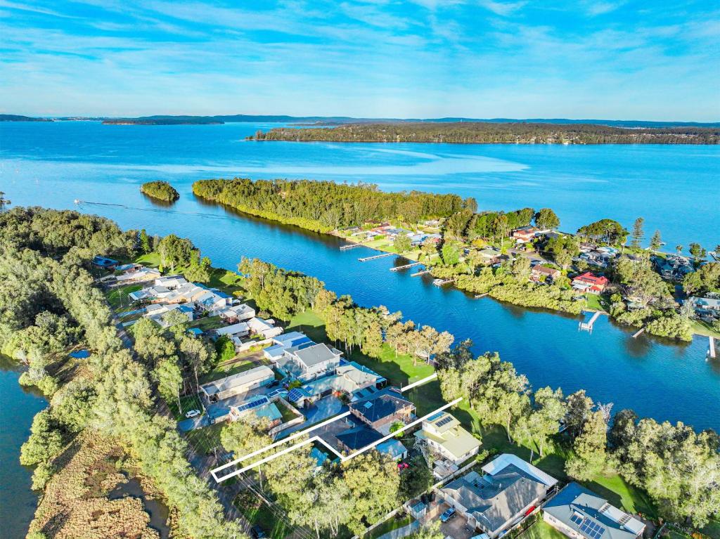 an aerial view of a resort on a river at Grandwater Escape in Dora Creek