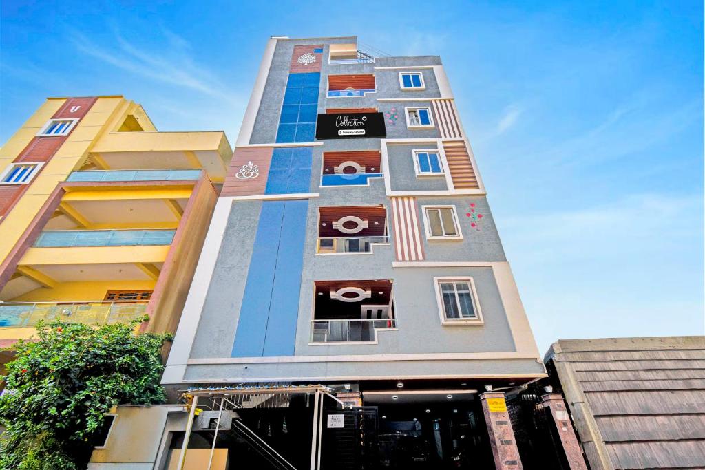 a tall building with colorful windows on the side of it at Super Collection O Gachibowli Phase 2 Formerly SK Stays in Gachibowli