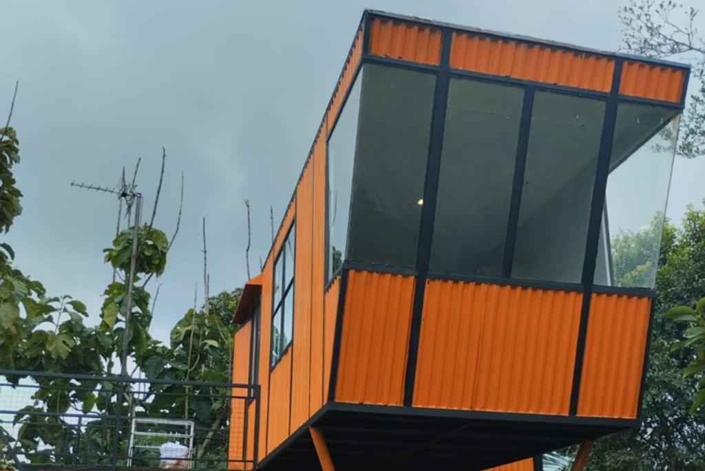 an orange building with windows on top of it at Cozzy D'Sobahan Resort in Ngadirejo