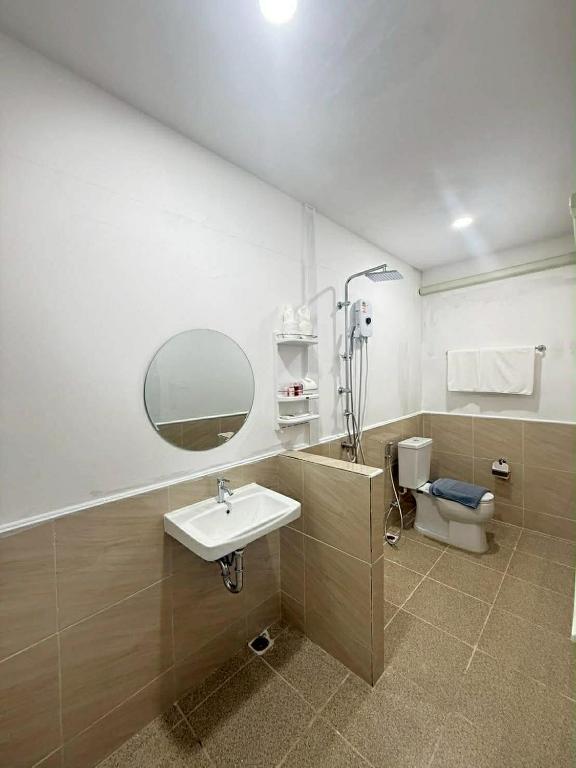 a bathroom with a sink and a toilet at DD Bangrak Hotel in Koh Samui