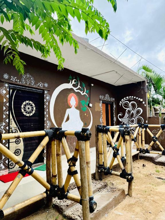 a building with a painting of a woman on it at Junglee tree stays in Hampi