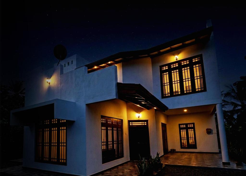 a house at night with its lights on at Ehana holiday in Tangalle