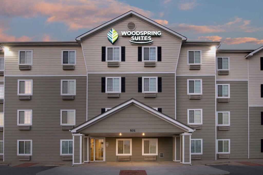 a building with a sign on the front of it at WoodSpring Suites Killeen in Killeen