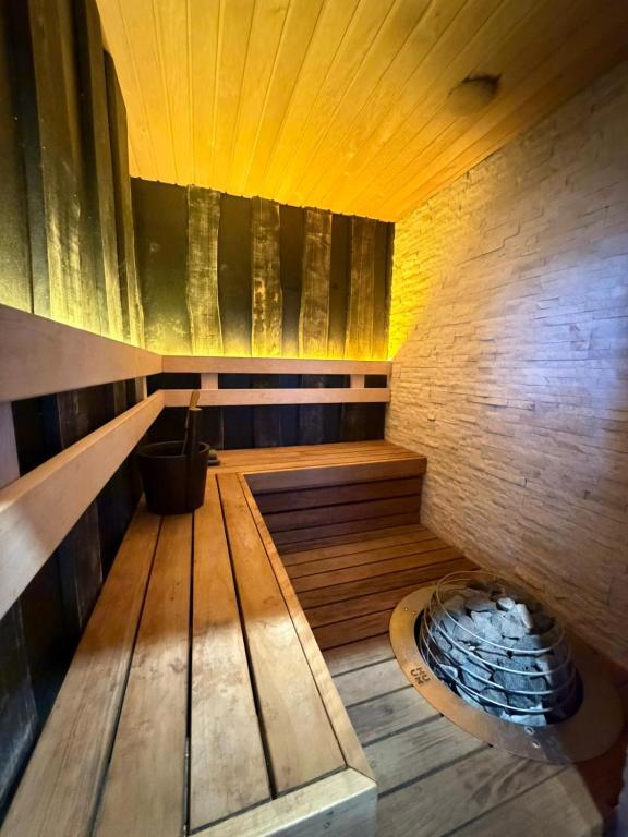 an empty sauna with wooden floors and a wooden ceiling at MaxiMar Apartment With Sauna in Valga