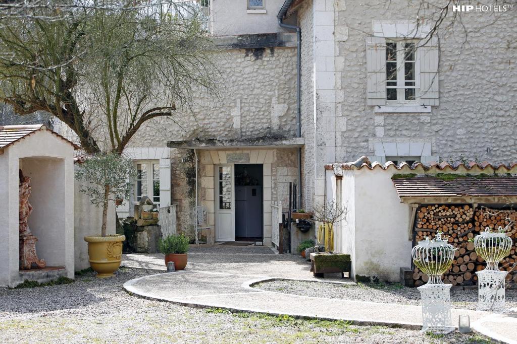 a house with a walkway leading to a door at Moulin De Larcy in Ribérac