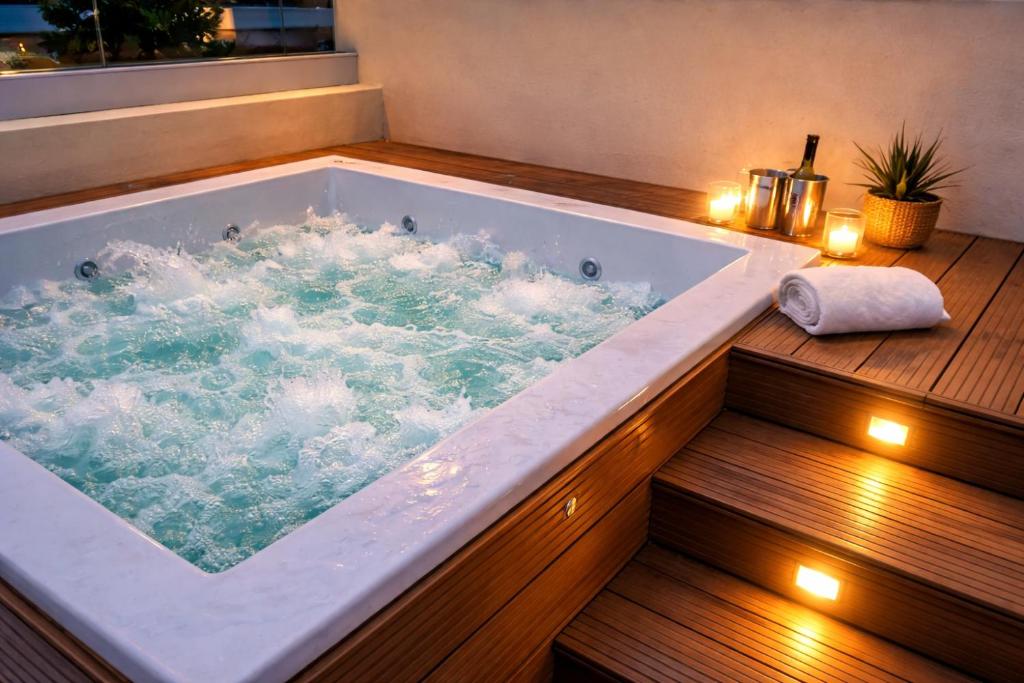 a large bath tub with lights on a wooden deck at Dream House Las Terrenas Terraza privada & Jacuzzi in Las Terrenas