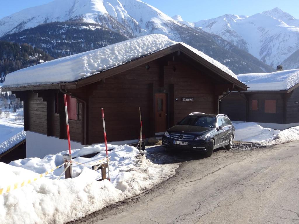 a car parked in front of a building with snow at Chalet in Wiler near Ski Lift & Views in Fiesch