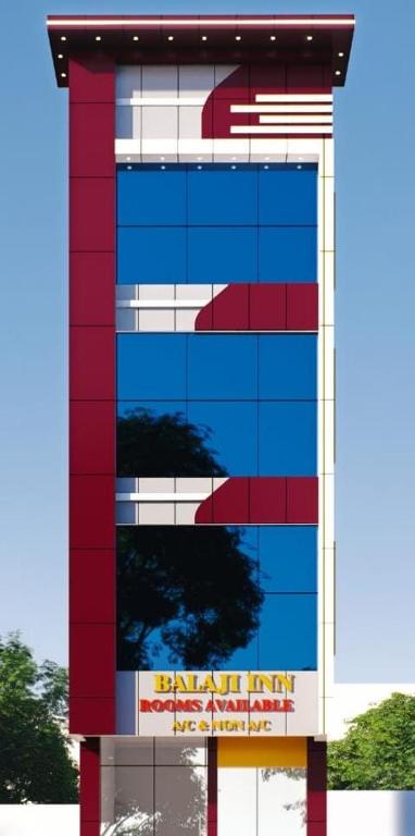 a red and white building with a sign on it at M Balaji inn in Vellore