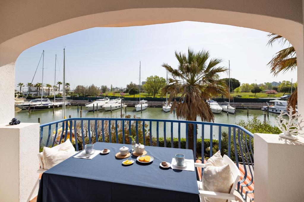 a blue table with food on a balcony with a marina at Casa Celeste Sea View - Riviera Collection in Misano Adriatico