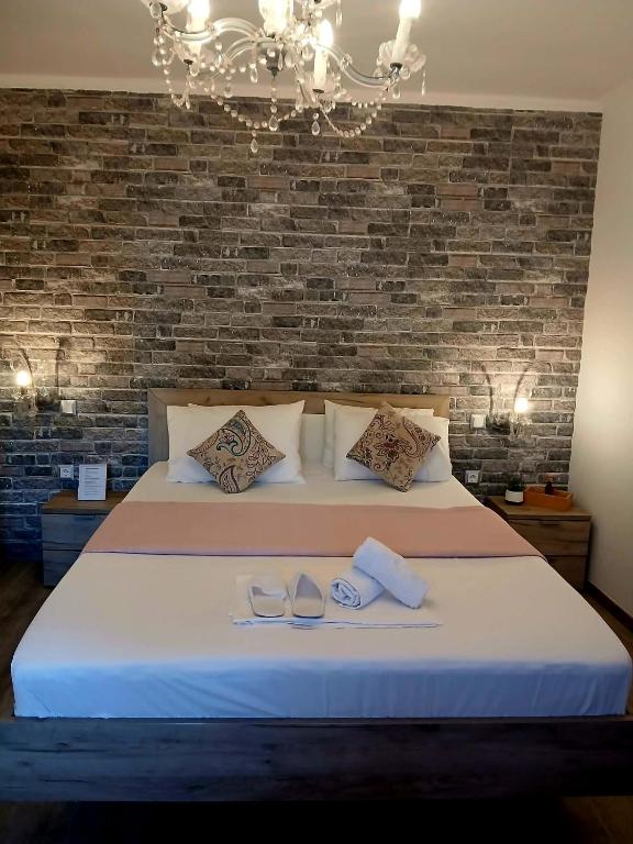 a bedroom with a bed with a brick wall at Melirito in Olympiada