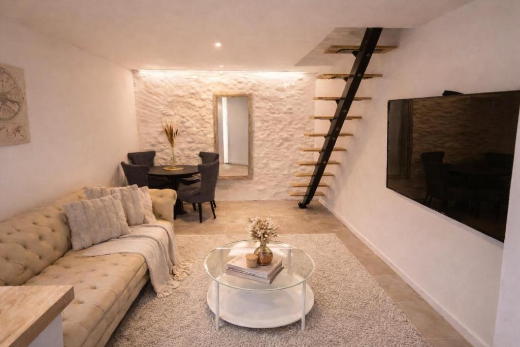 a living room with a couch and a table at Maison cosy proche plage in Elne