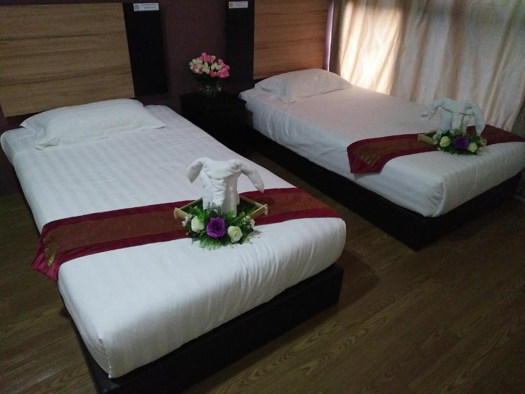 Postel nebo postele na pokoji v ubytování Amigo Hotel