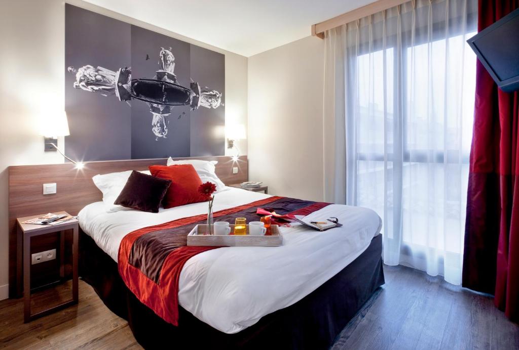 Krevet ili kreveti u jedinici u objektu Aparthotel Adagio Aix-en-Provence Centre