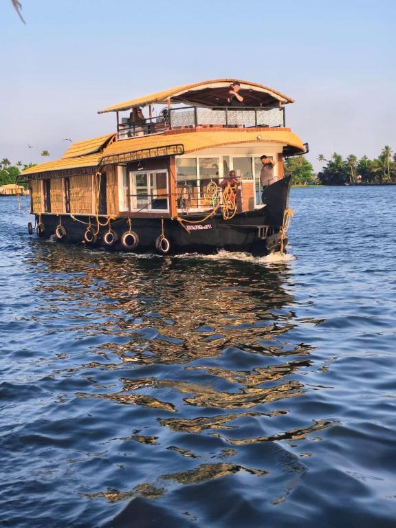 a boat in the water on the water at Elagance Premium Houseboats in Alleppey
