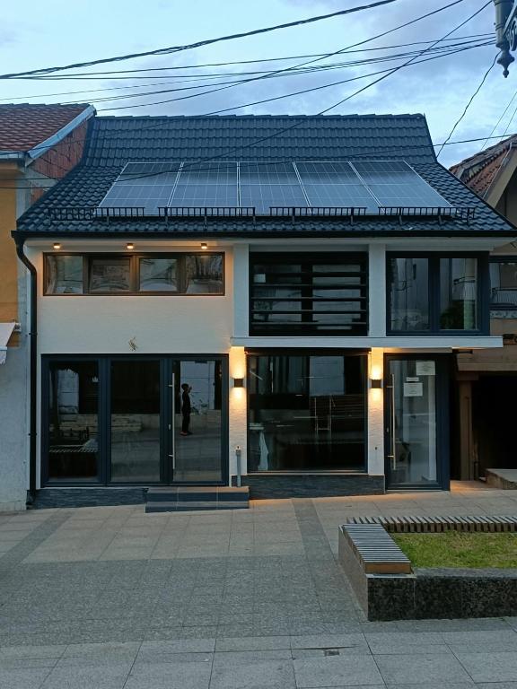 a house with solar panels on top of it at UB Prenociste in Vranjska Banja