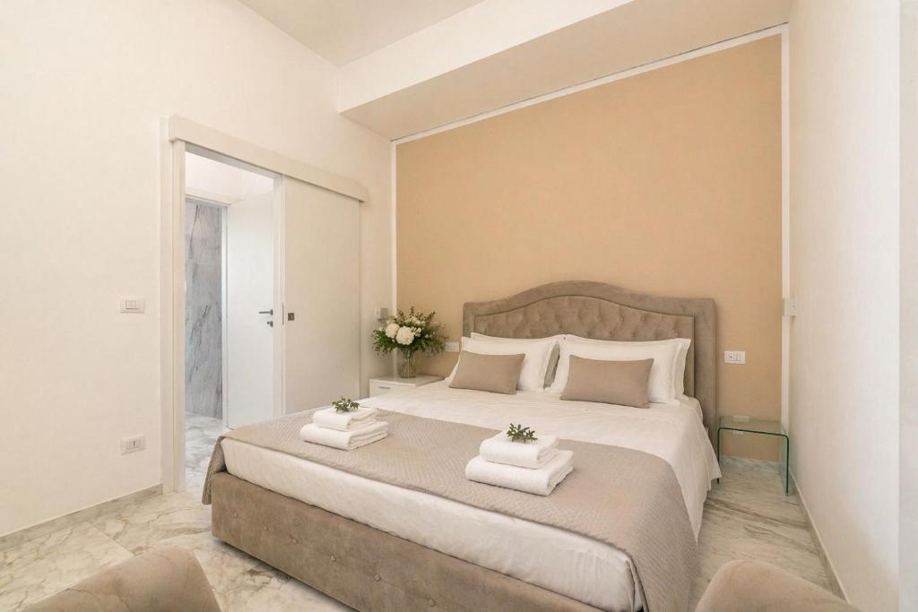 a bedroom with a large bed with two pillows at Frontemare Apartment by Symphonya Luxury Holiday Rentals in Gallipoli
