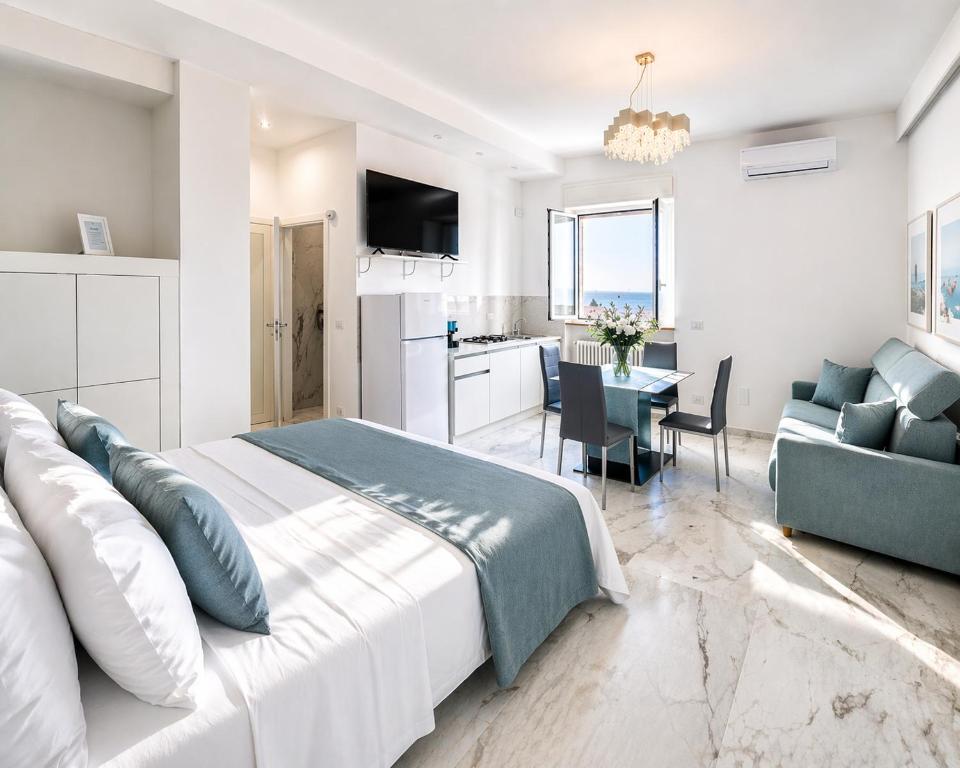 a bedroom with a bed and a living room at White Loft by Symphonya Luxury Holiday Rentals in Gallipoli