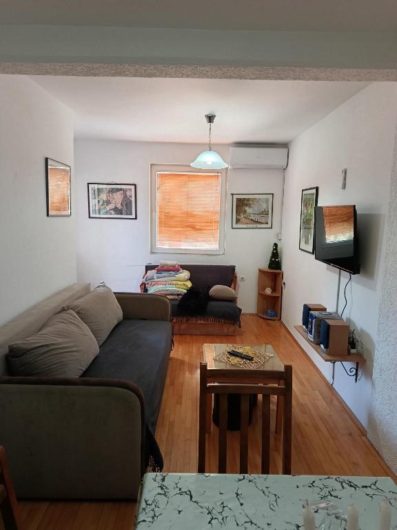 a living room with a couch and a table at Apartman SAN in Soko Banja
