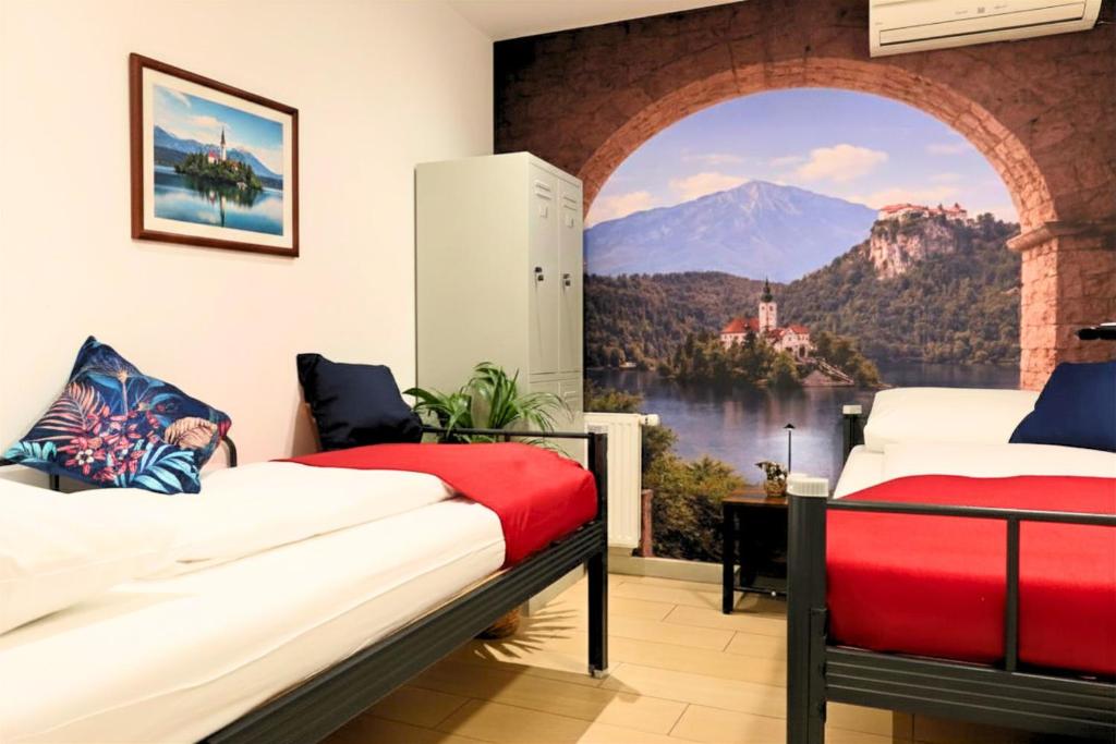 a room with two beds and a view of a mountain at Old Town Guest Accommodation in Kranj