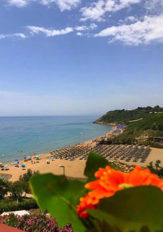 a view of a beach with umbrellas and the ocean at Appartamenti Onde Blu in Le Castella