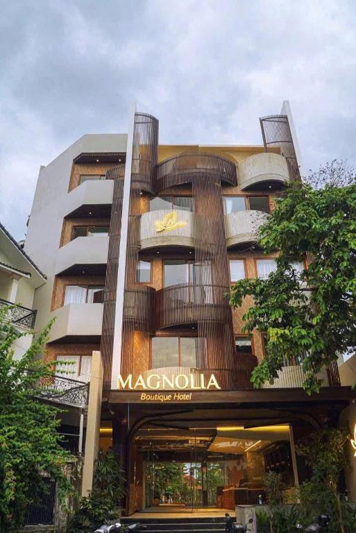a large building with a sign on the front of it at Magnolia Boutique Hue in Thôn Trường Giang