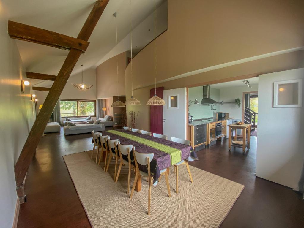 a dining room and kitchen with a table and chairs at Gîte Le Cot en Vallée d'Ossau in Sainte-Colome
