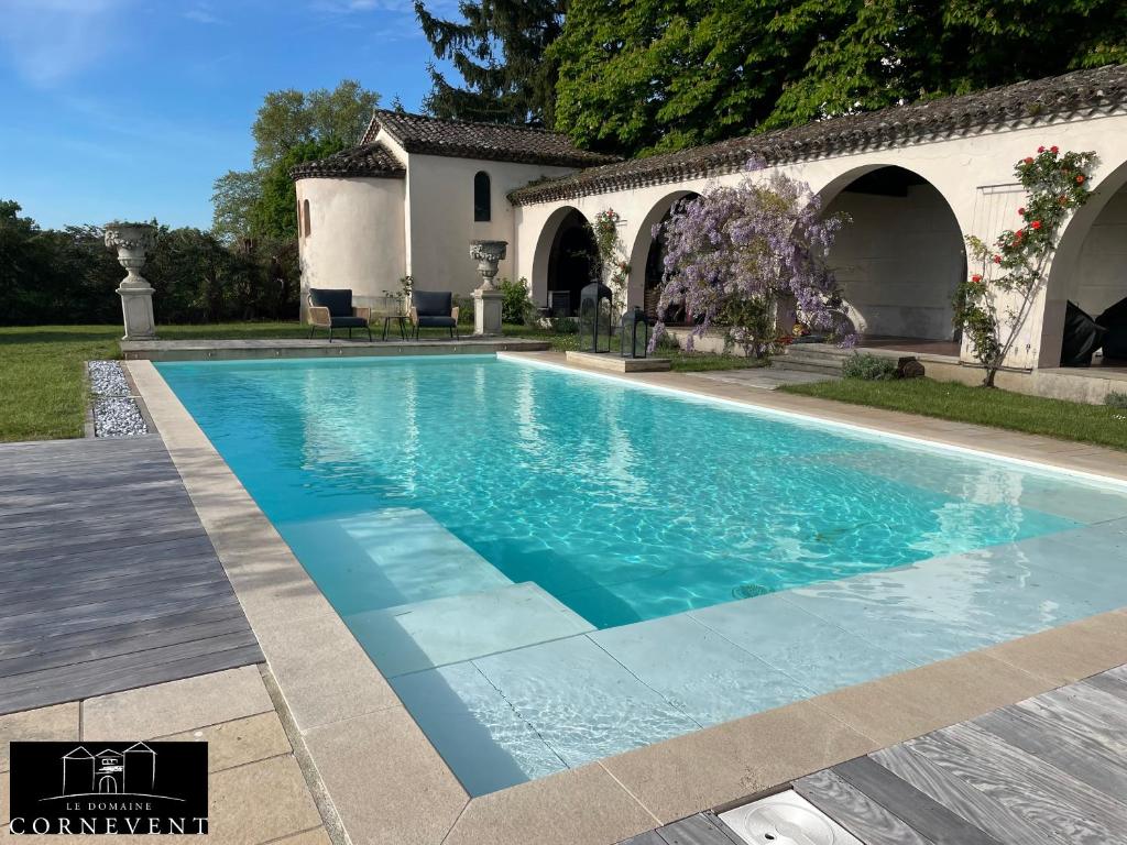 a swimming pool in the backyard of a house at Appartement cocon de charme, Domaine Cornevent Lyon, parc & piscine in Vernaison