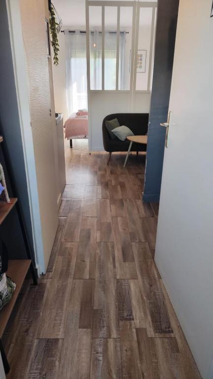 a hallway with a wooden floor in a room at Studio St Marc - plage à 300m in Saint-Nazaire